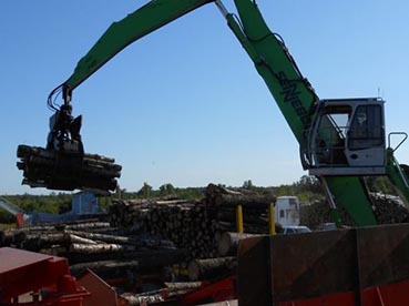 Wood being loaded by yard loader for the chipper